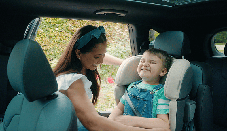 Veena Helping Max With His Seatbelt In The Kia Sorento
